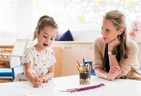 A therapist working one-on-one with a child at a table